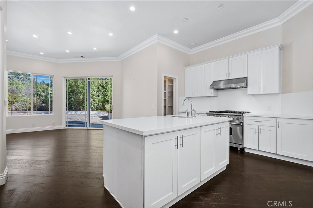 166 Dapplegray Road Bell Canyon, CA 91307 - Photo 14 of 57 a kitchen that has a lot of white cabinets and wooden floor