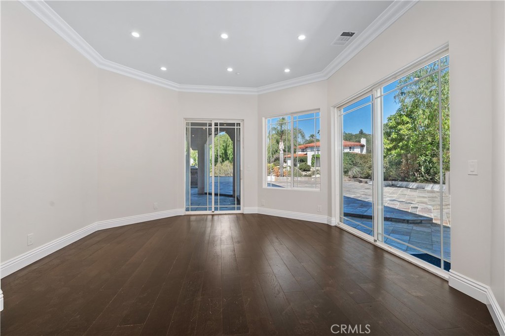 166 Dapplegray Road Bell Canyon, CA 91307 - Photo 15 of 57 an empty room with wooden floor and windows