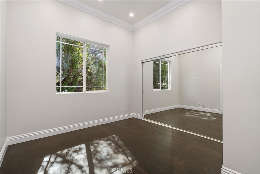 166 Dapplegray Road Bell Canyon, CA 91307 - Photo 18 of 57 a view of an empty room with wooden floor and a window