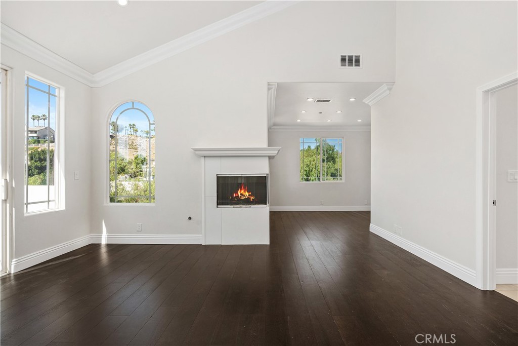 166 Dapplegray Road Bell Canyon, CA 91307 - Photo 22 of 57 an empty room with windows and wooden floor