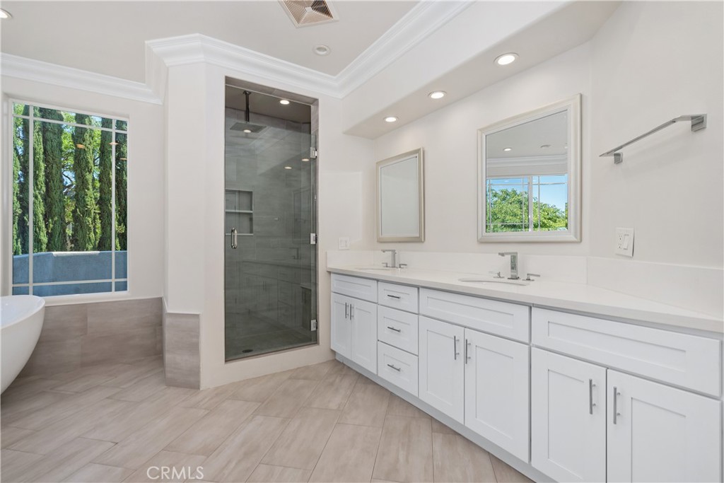 166 Dapplegray Road Bell Canyon, CA 91307 - Photo 24 of 57 a bathroom with a double vanity sink a mirror and a bathtub