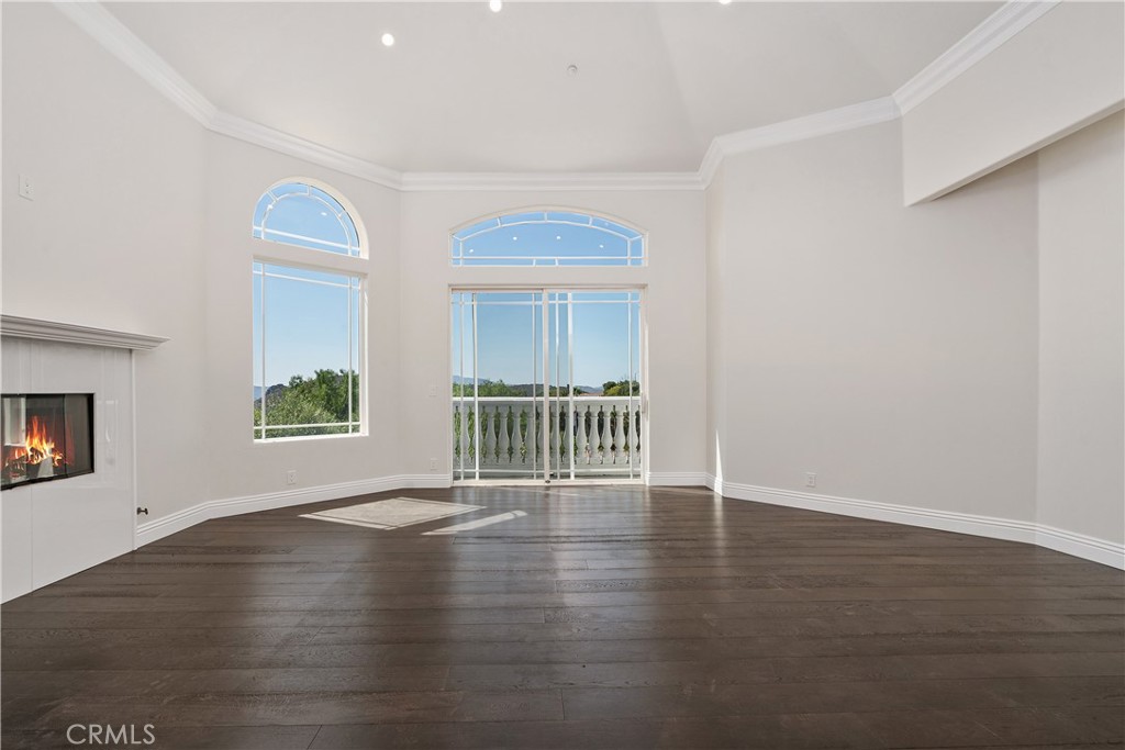 166 Dapplegray Road Bell Canyon, CA 91307 - Photo 31 of 57 a view of an empty room with a window and wooden floor
