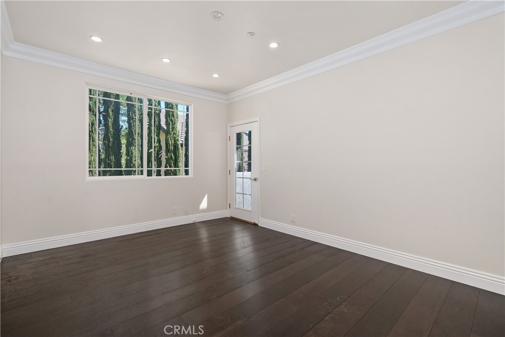 166 Dapplegray Road Bell Canyon, CA 91307 - Photo 32 of 57 an empty room with wooden floor and windows
