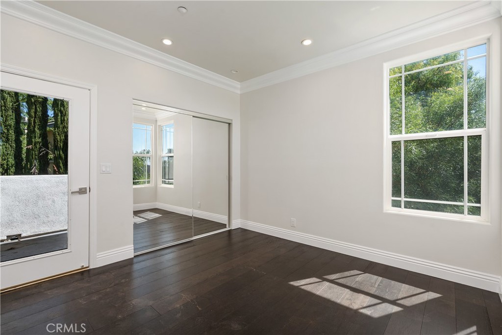 166 Dapplegray Road Bell Canyon, CA 91307 - Photo 36 of 57 an empty room with wooden floor and windows