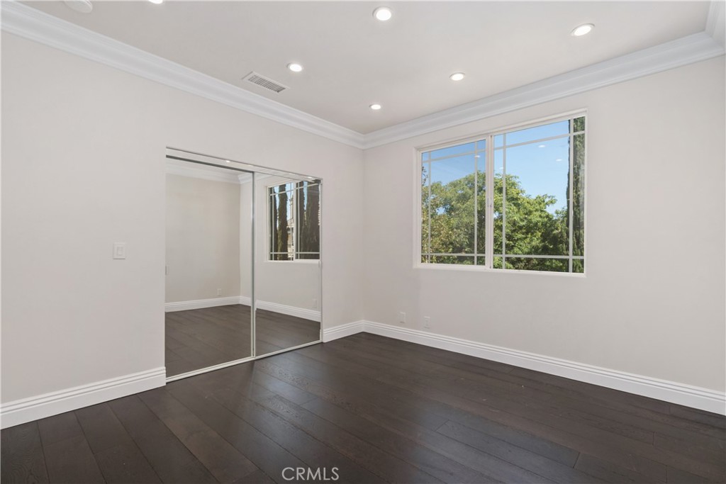 166 Dapplegray Road Bell Canyon, CA 91307 - Photo 37 of 57 an empty room with wooden floor and windows