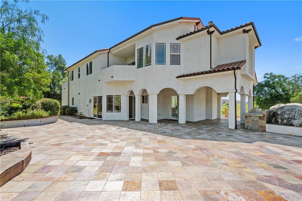 166 Dapplegray Road Bell Canyon, CA 91307 - Photo 41 of 57 a view of a white house with large trees and outdoor space