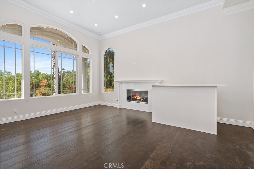 166 Dapplegray Road Bell Canyon, CA 91307 - Photo 5 of 57 an empty room with wooden floor and windows