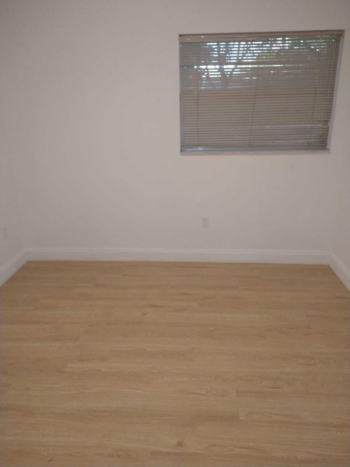 8321 Sands Point Boulevard, Unit D109 Tamarac, FL 33321 - Photo 12 of 16 a view of wooden floor and white wall