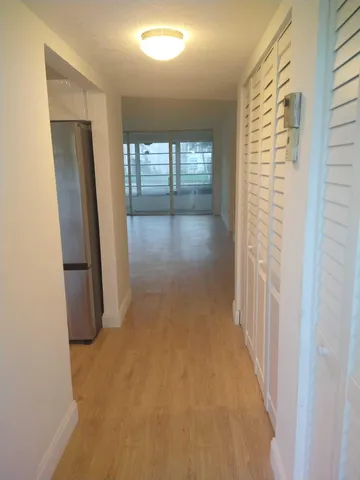 an empty room with closet and mirror