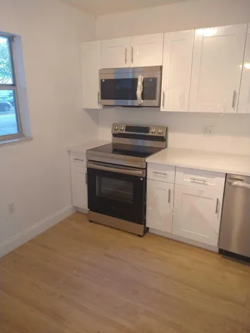 a white refrigerator freezer sitting in a kitchen