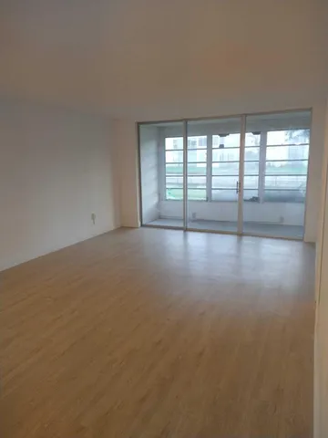 an empty room with closet and mirror