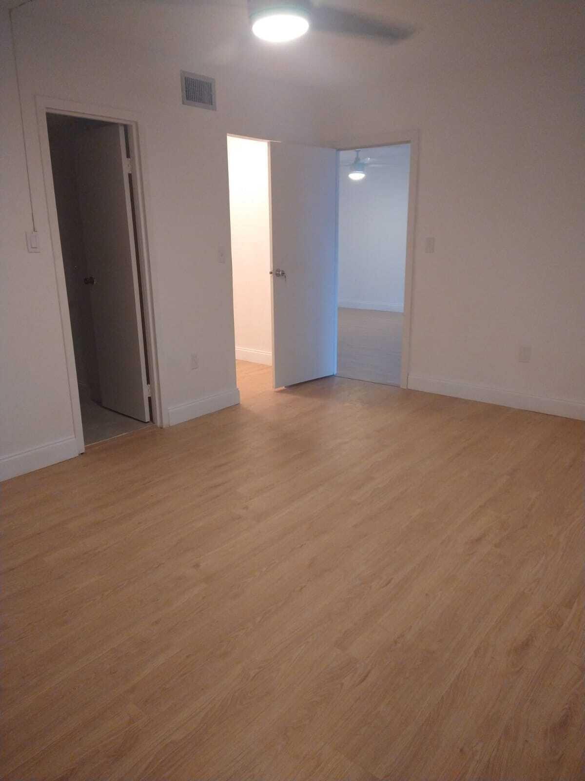 8321 Sands Point Boulevard, Unit D109 Tamarac, FL 33321 - Photo 7 of 16 an empty room with closet and mirror