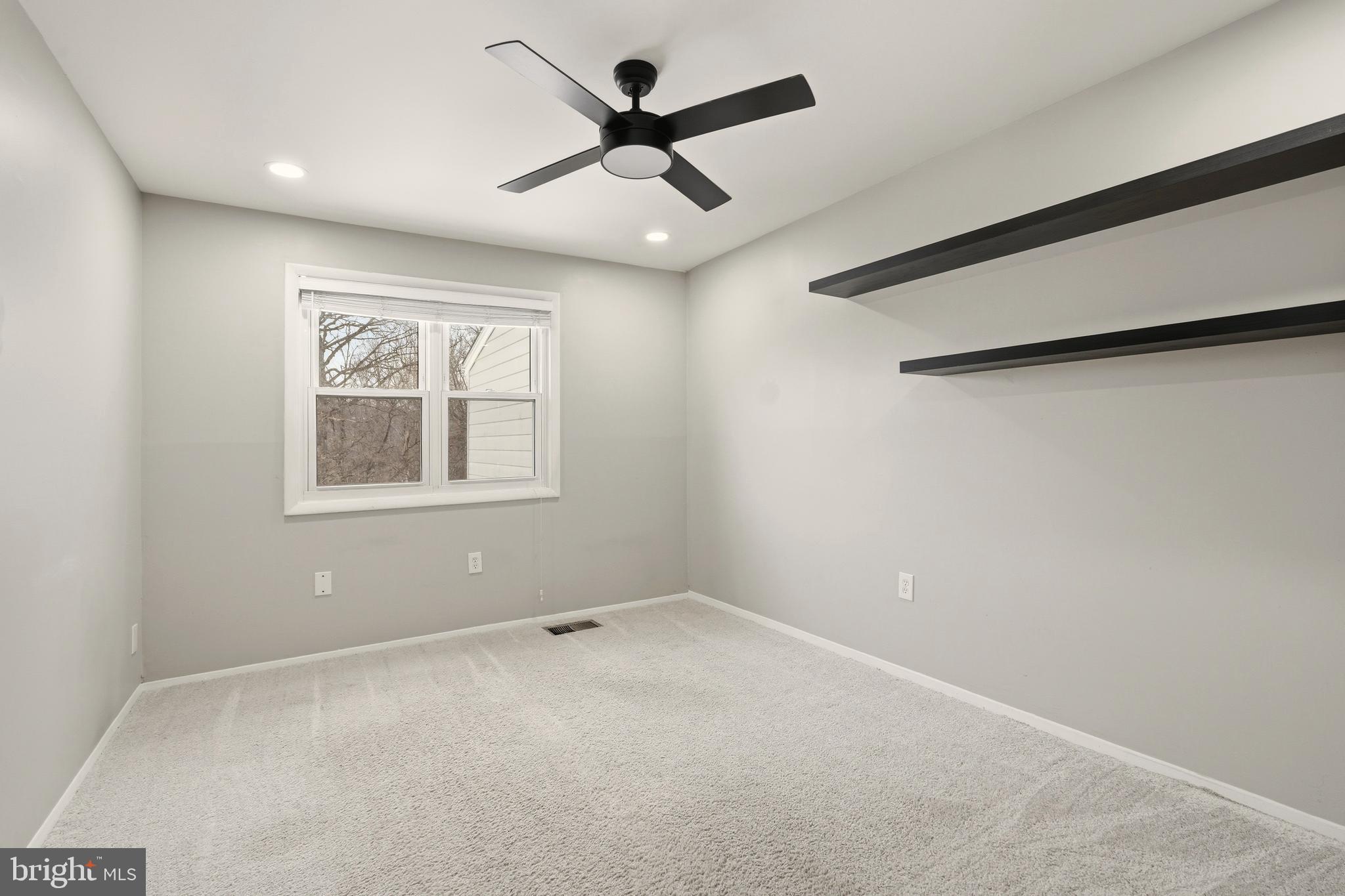 7712 Erica Lane Laurel, MD 20707 - Photo 20 of 35 an empty room with a window and a ceiling fan