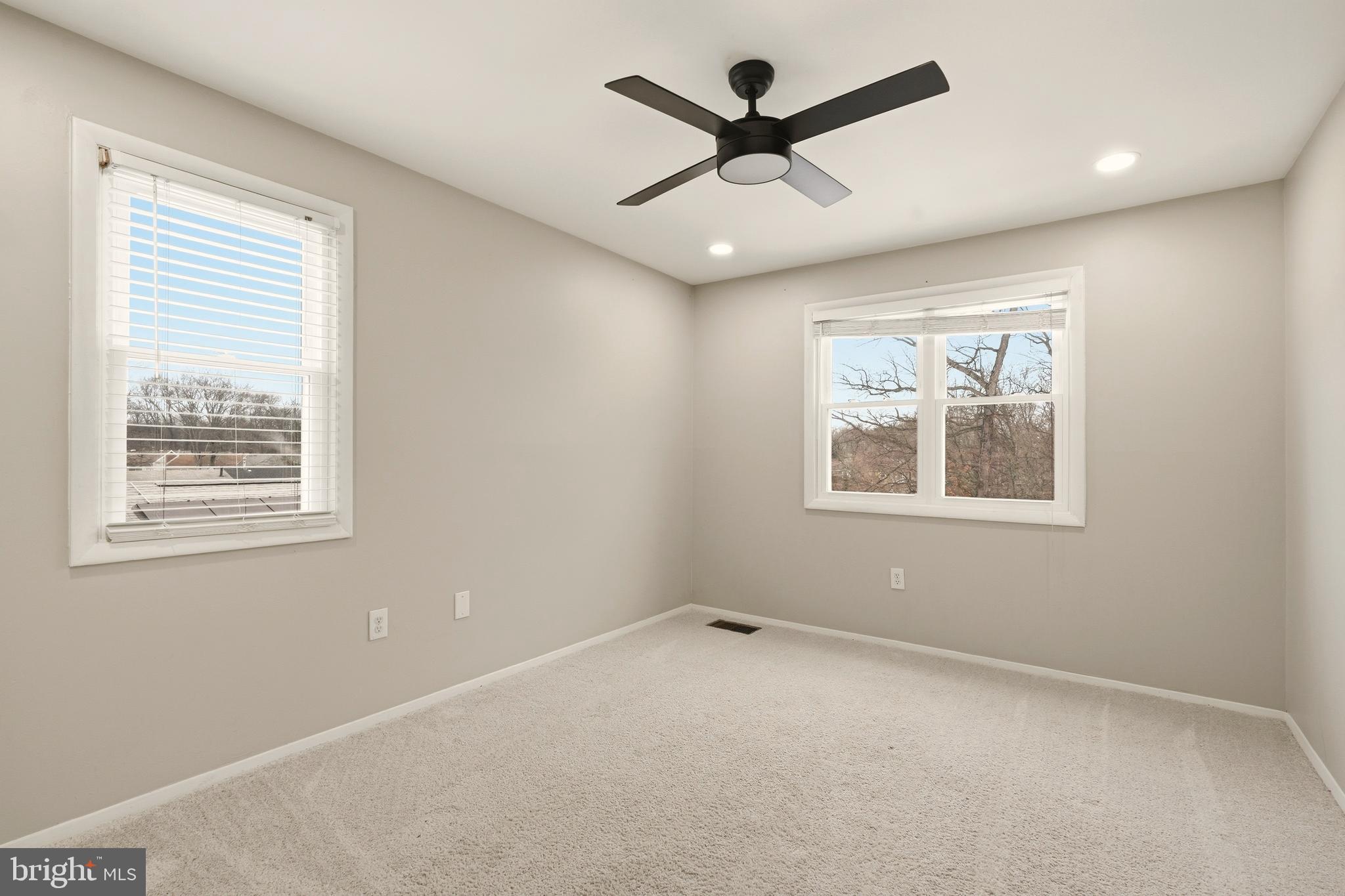 7712 Erica Lane Laurel, MD 20707 - Photo 22 of 35 an empty room with a window and a ceiling fan