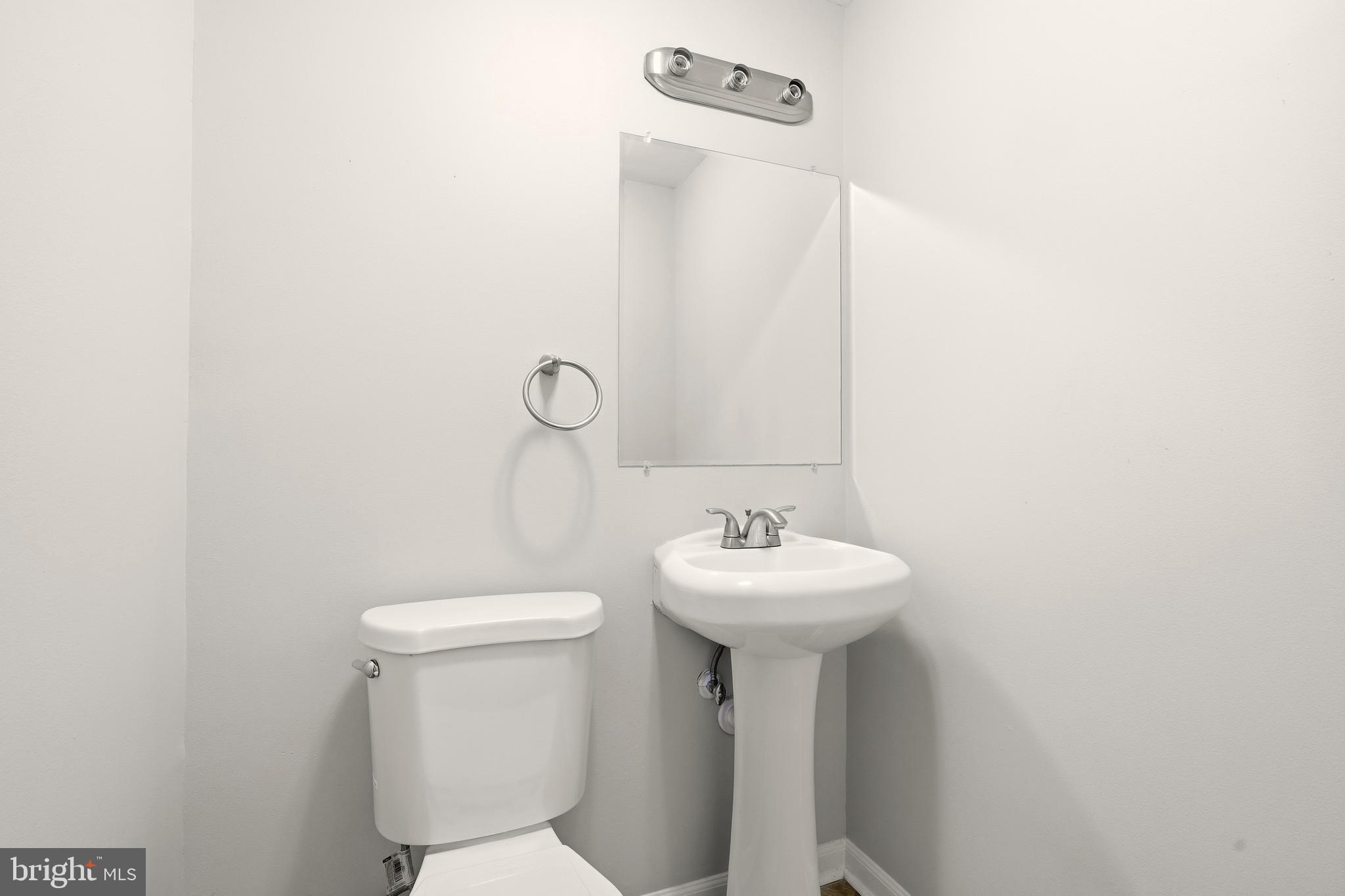 7712 Erica Lane Laurel, MD 20707 - Photo 27 of 35 a bathroom with a sink a mirror and toilet