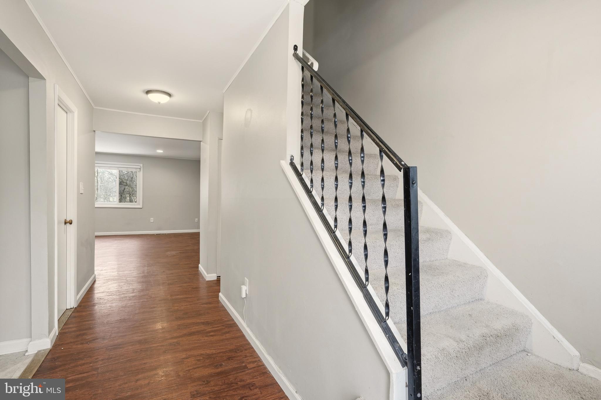 7712 Erica Lane Laurel, MD 20707 - Photo 4 of 35 a view of a hallway with wooden floor and staircase