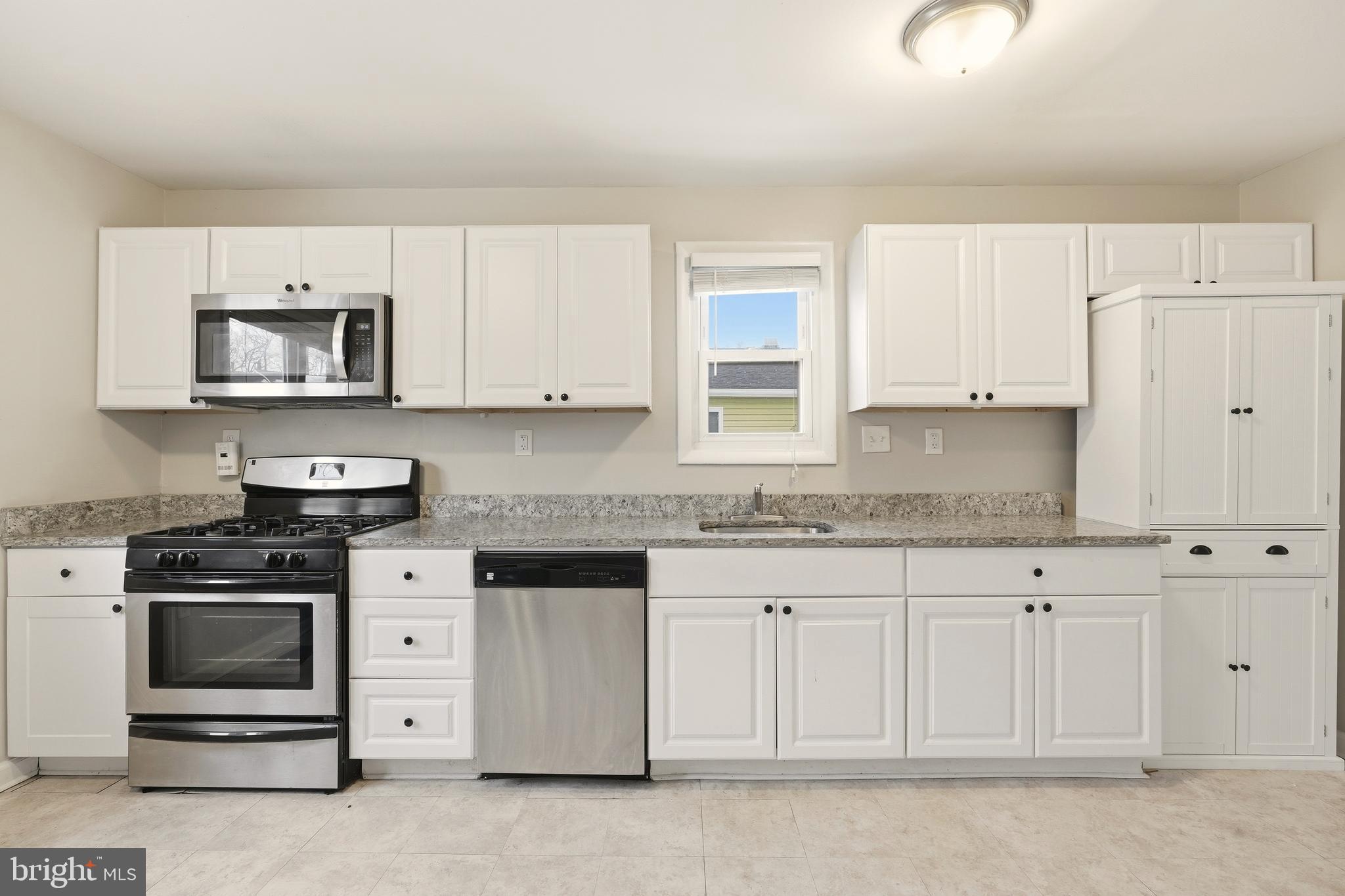 7712 Erica Lane Laurel, MD 20707 - Photo 7 of 35 a kitchen with granite countertop white cabinets and stainless steel appliances