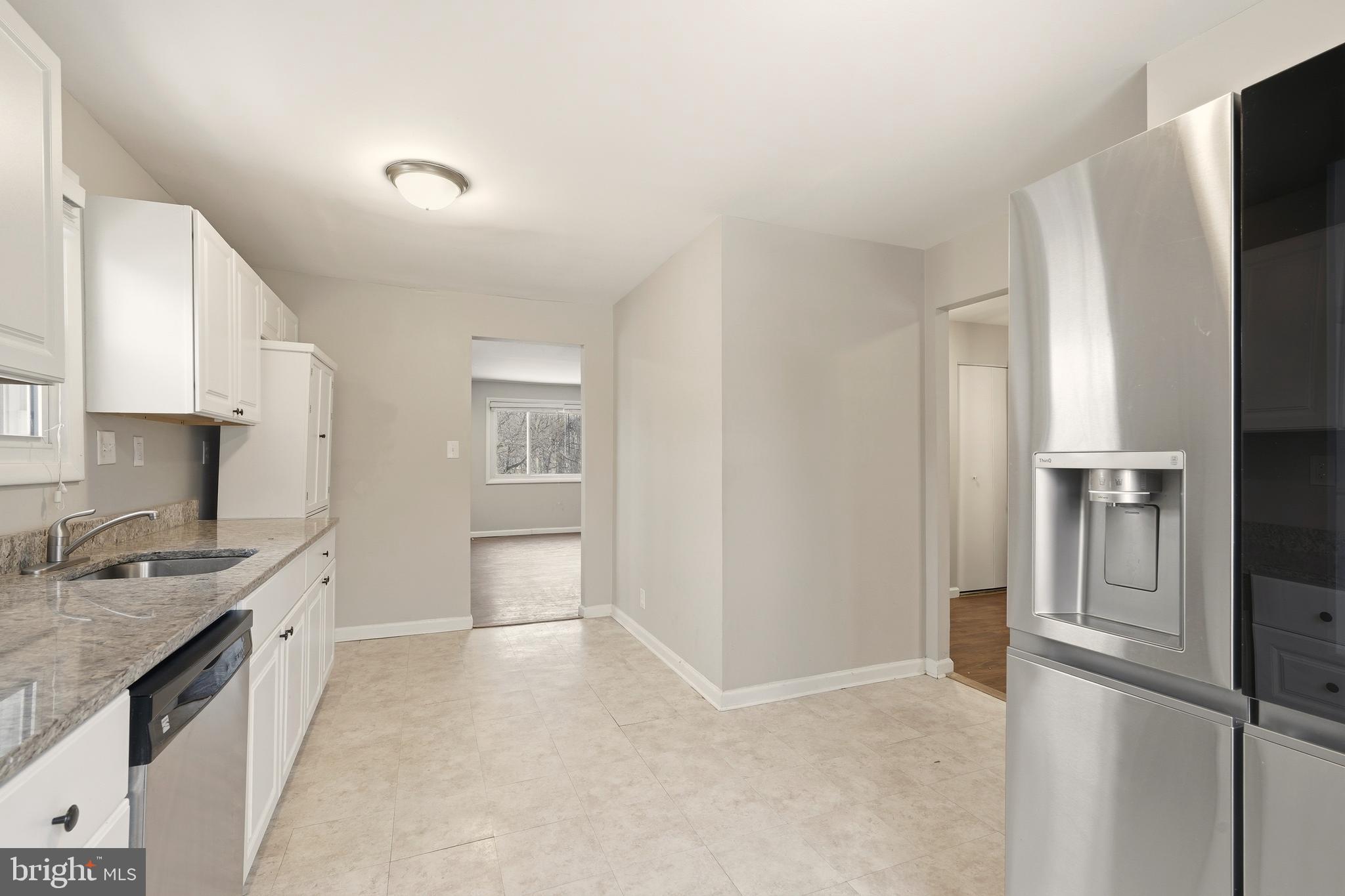 7712 Erica Lane Laurel, MD 20707 - Photo 9 of 35 a kitchen with a refrigerator and a sink