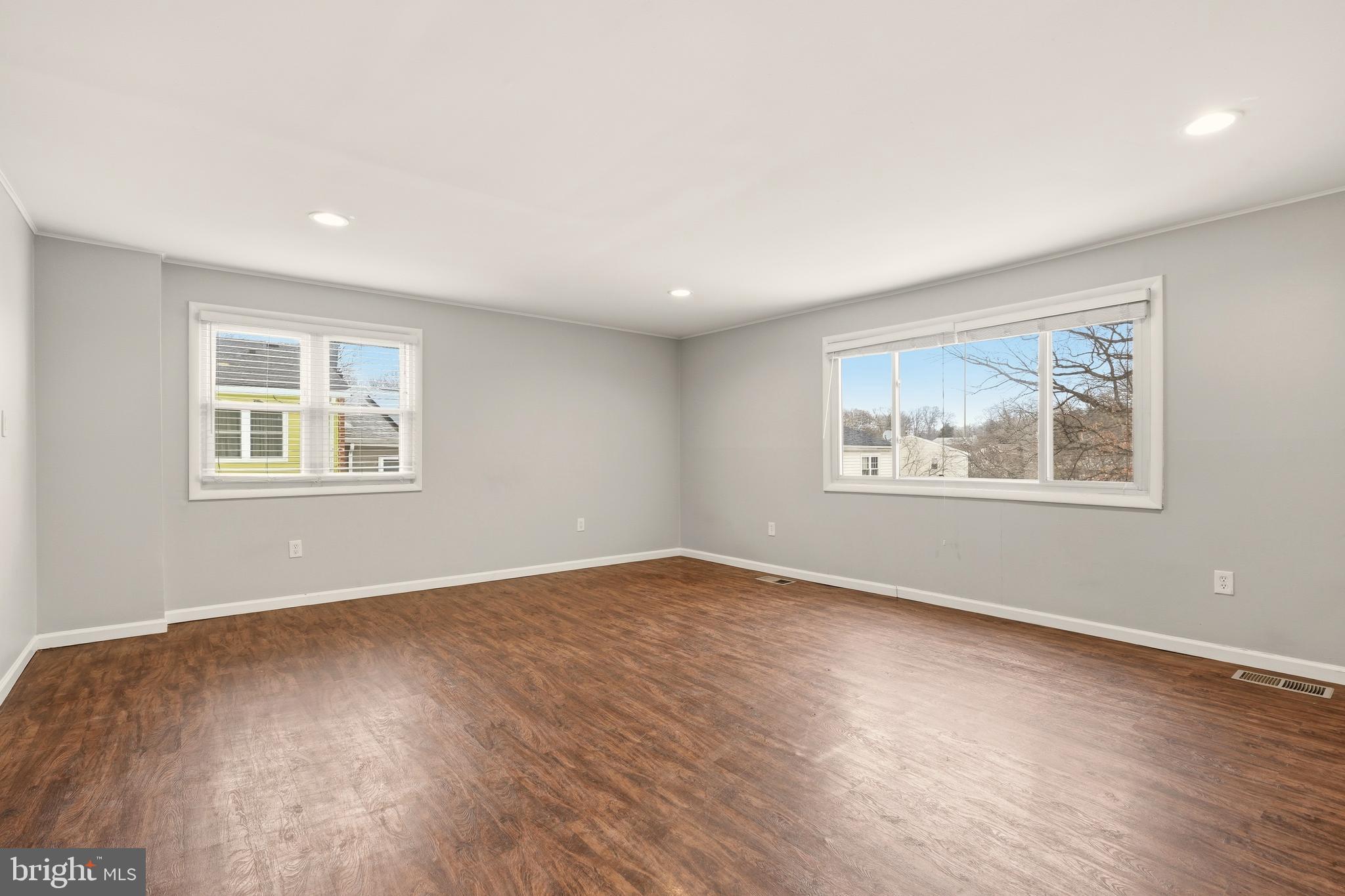 7712 Erica Lane Laurel, MD 20707 - Photo 10 of 35 a view of an empty room with wooden floor and a window