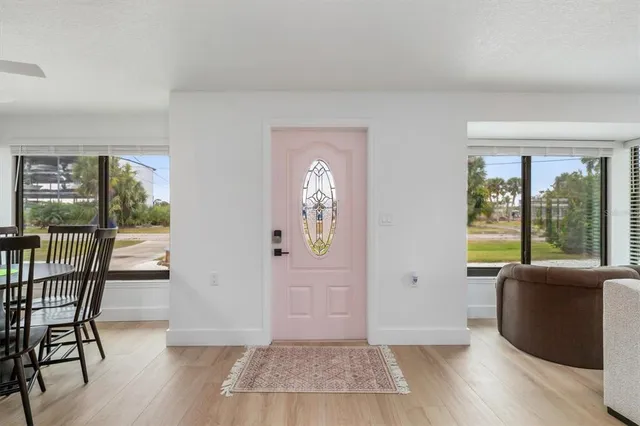 a view of a livingroom with furniture wooden floor and windows