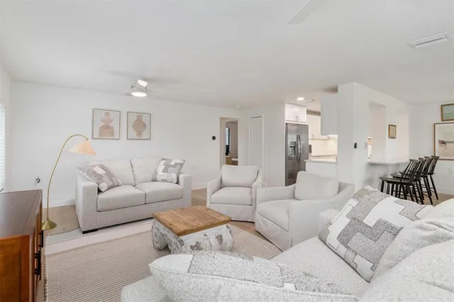 a living room with furniture and a large white bed