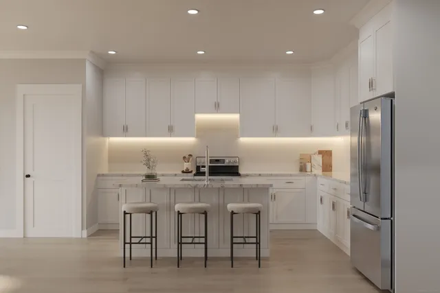 a kitchen with cabinets and chairs