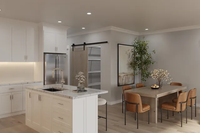 a kitchen with granite countertop a table and chairs in it