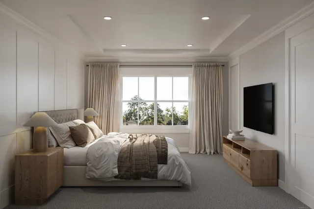 a bedroom with a bed and a flat tv screen on the dresser