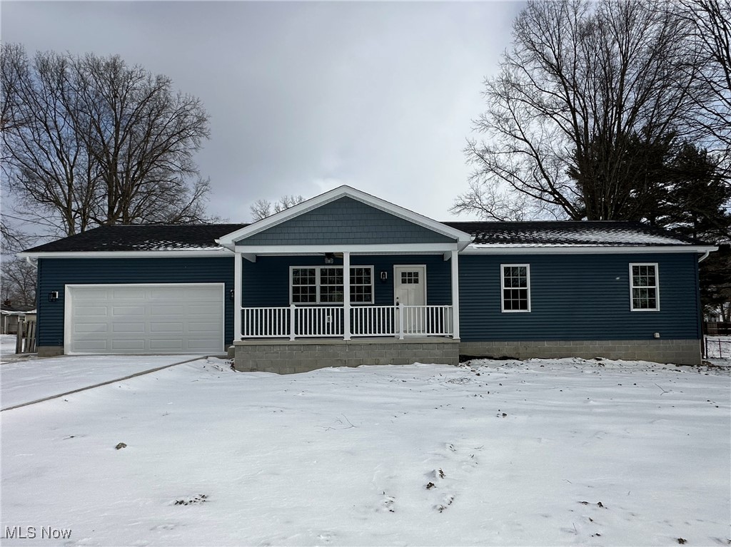 1275 South Meridian Road Youngstown, OH 44511 - Photo 1 of 16 Ranch-style home featuring an attached garage and a porch
