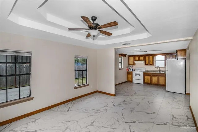 a view of a livingroom with a ceiling fan and window