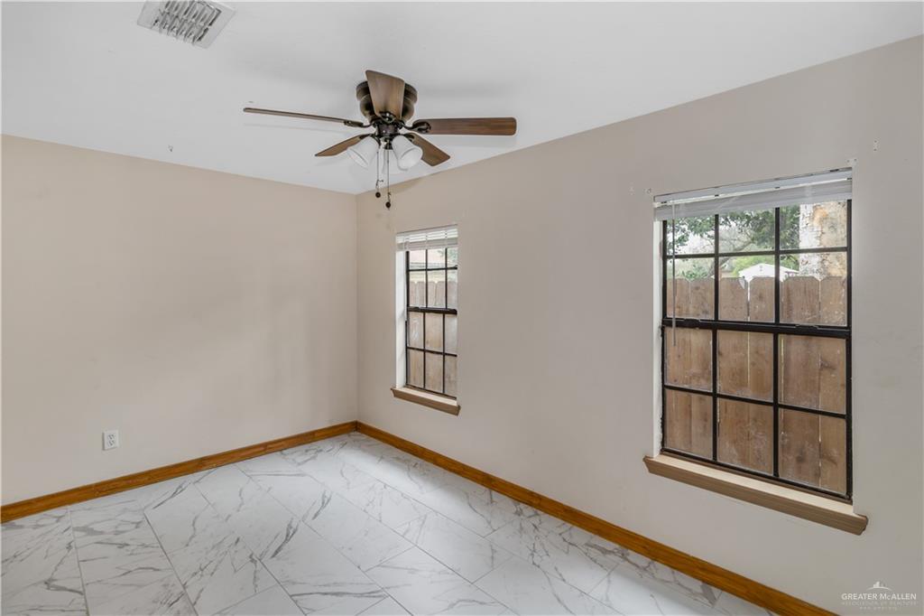 305 East Santa Rosa Avenue Edcouch, TX 78538 - Photo 5 of 9 an empty room with windows and fan