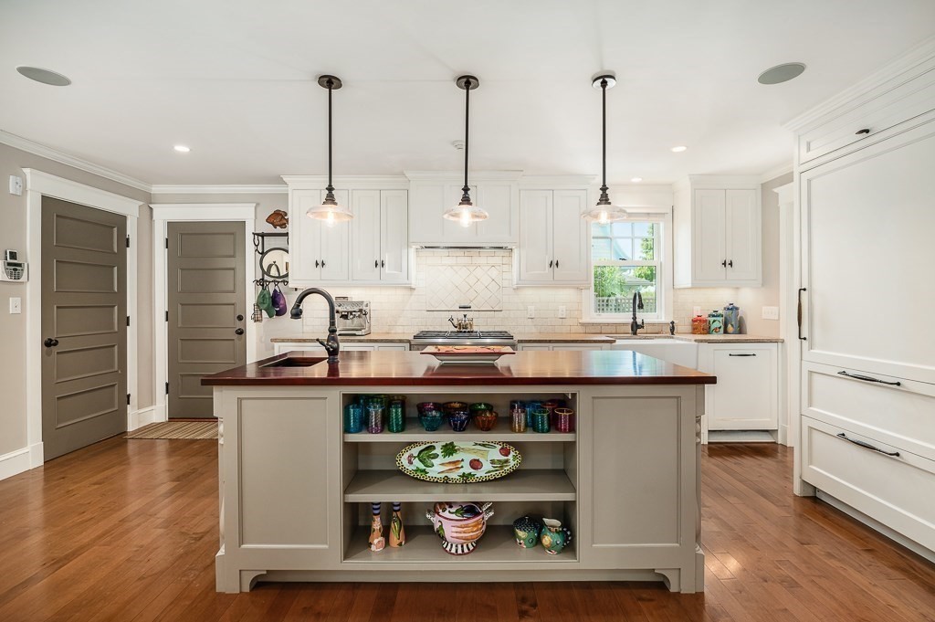 3 Grapevine Road Gloucester, MA 01930 - Photo 11 of 32 a kitchen with stainless steel appliances kitchen island granite countertop a stove a sink and a wooden floors