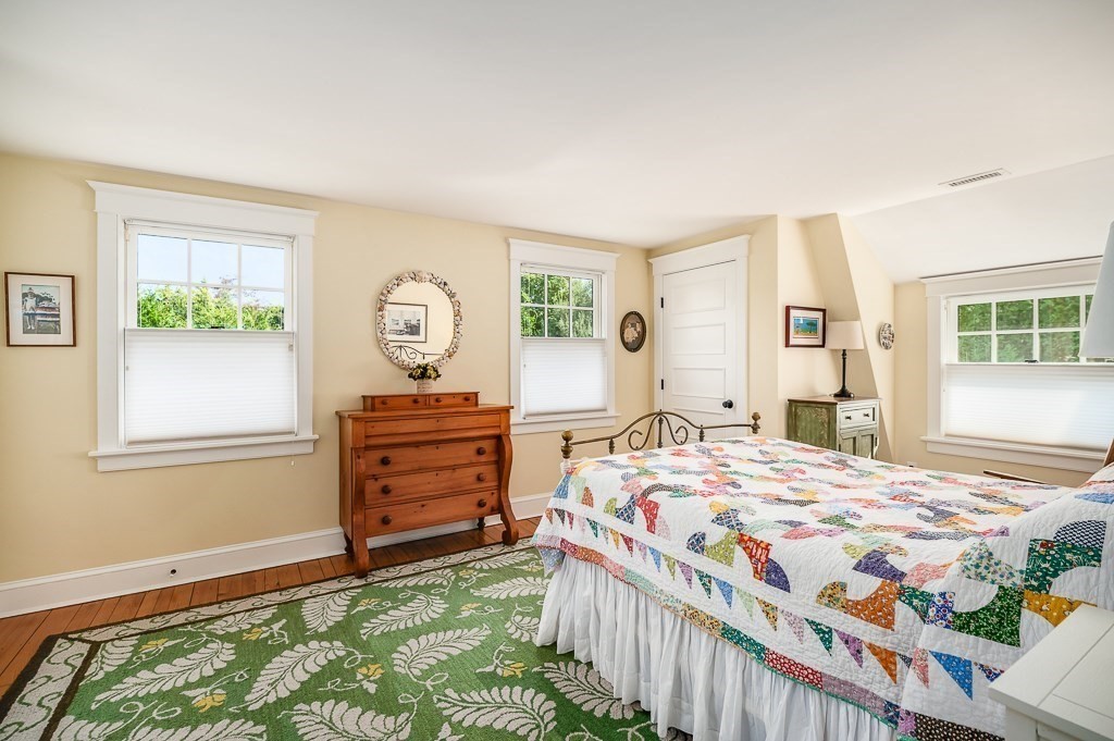 3 Grapevine Road Gloucester, MA 01930 - Photo 17 of 32 a bedroom with a bed and a dresser next to a window