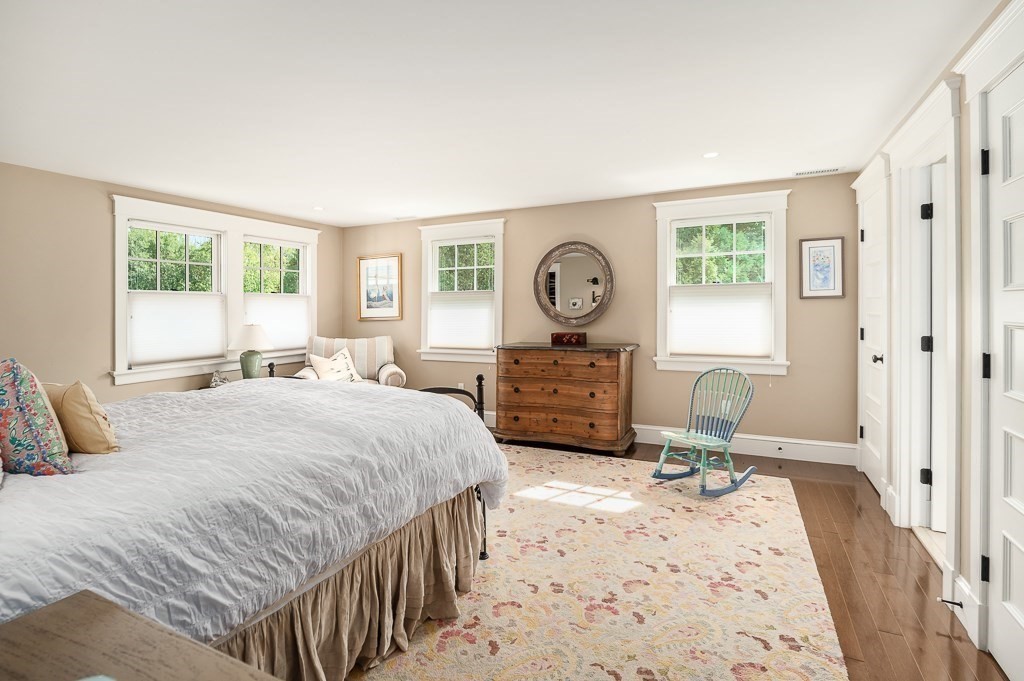 3 Grapevine Road Gloucester, MA 01930 - Photo 22 of 32 a bedroom with a bed a mirror on dresser and a window