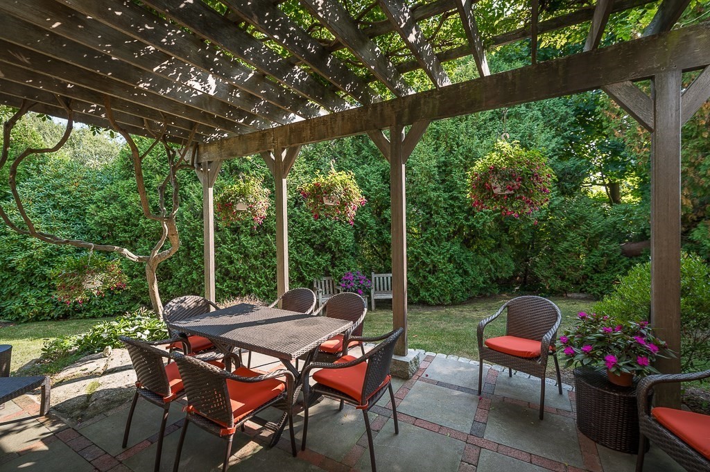 3 Grapevine Road Gloucester, MA 01930 - Photo 28 of 32 a backyard of a house with a table and chairs