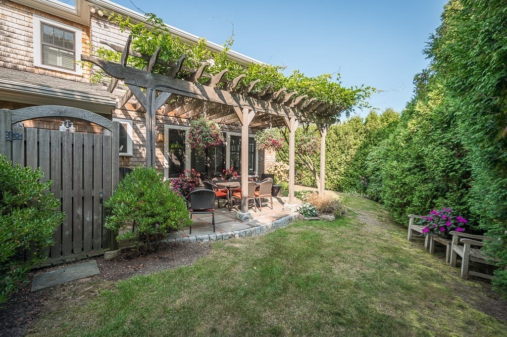 3 Grapevine Road Gloucester, MA 01930 - Photo 30 of 32 a view of a chair and table in backyard of the house