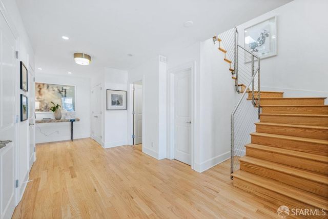 a view of a room with wooden floor and stairs