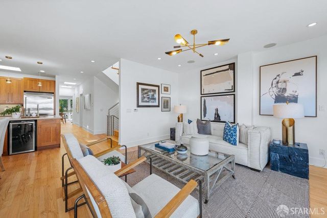 a view of a hallway with wooden floor and furniture