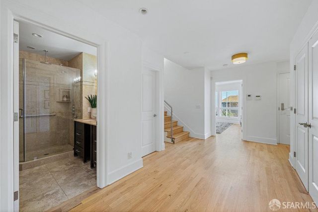 a view of a hallway view with wooden floor and staircase