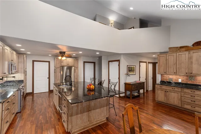 a living room with lots of furniture and kitchen view