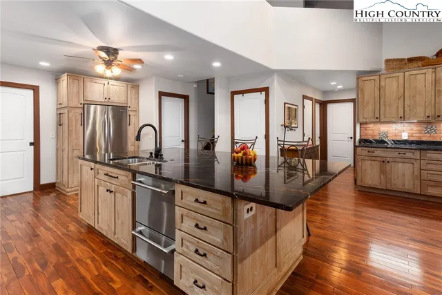 a kitchen with stainless steel appliances a stove a microwave oven cabinets and a counter top space