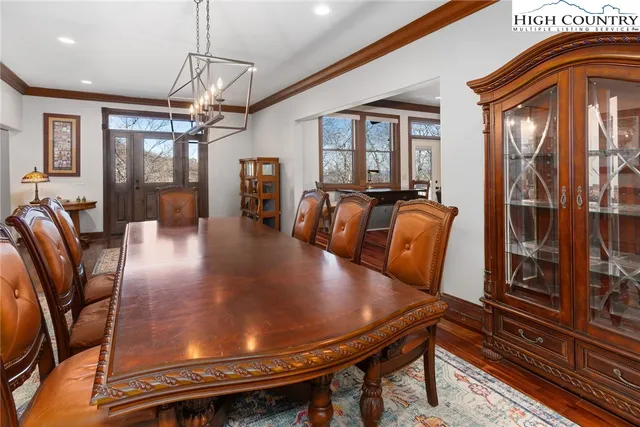 a view of a hallway with wooden floor and windows