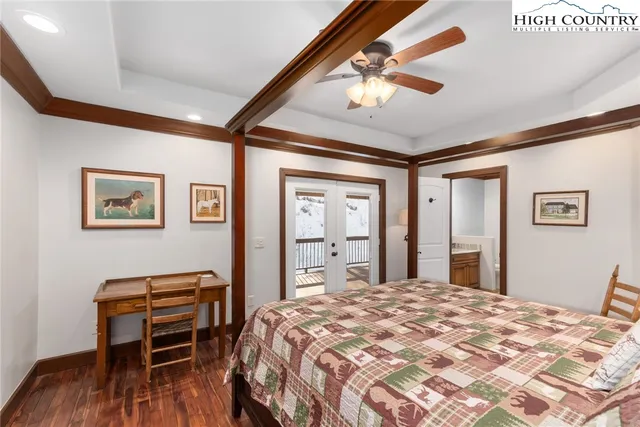 a bedroom with a bed window and a table