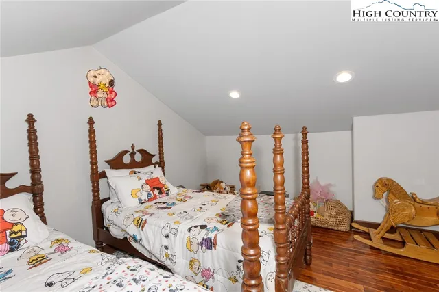 a bed room with furniture and a wooden floor