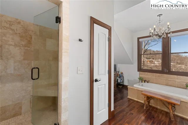 a very nice looking room with a large window and wooden floor