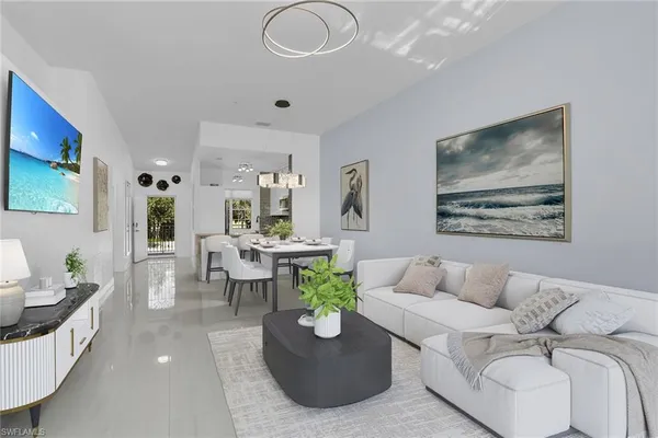 a living room with furniture and a chandelier