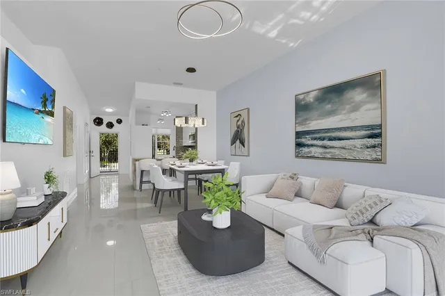 a living room with furniture and a chandelier