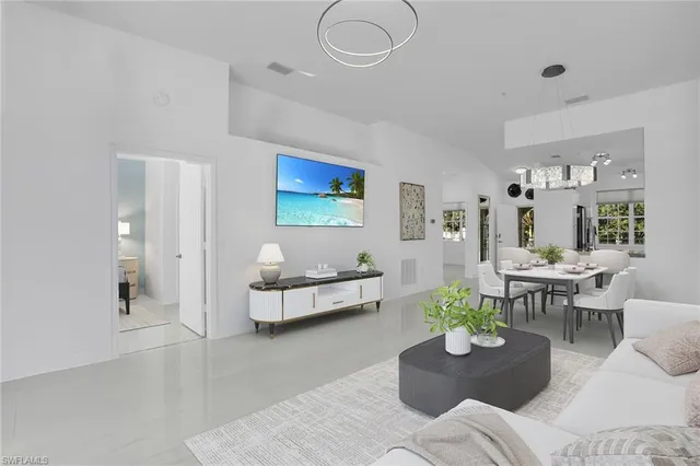 a living room with furniture potted plant and windows