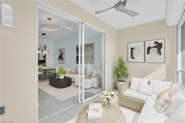 a living room with furniture and view of kitchen