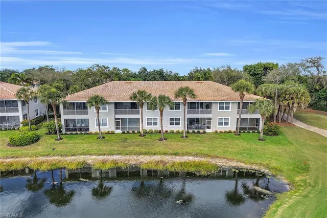 an aerial view of a house with swimming pool garden and trees